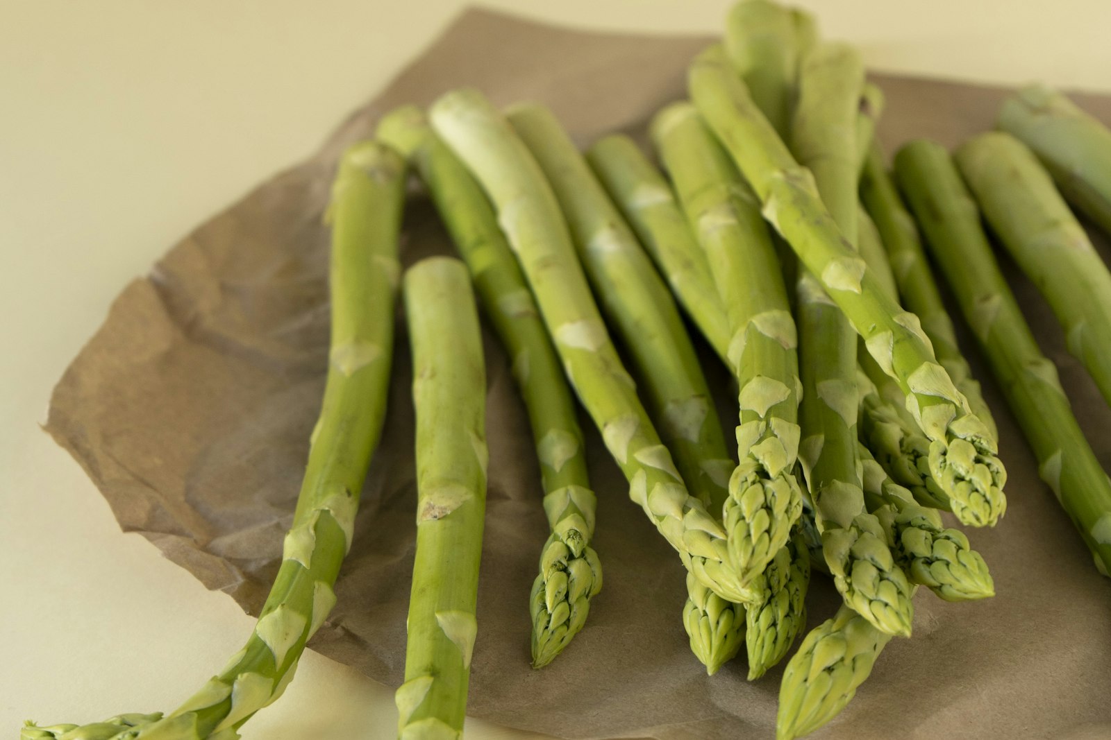 Fresh asparagus and spring vegetables on a wooden surface