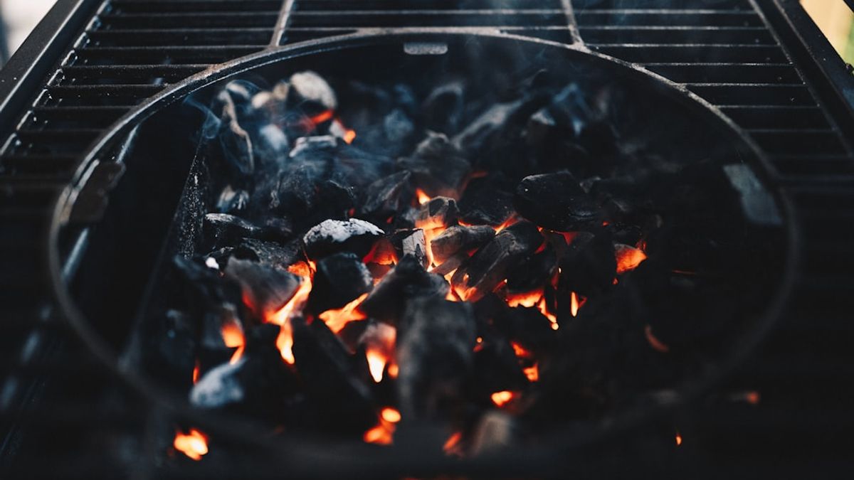 Roasting wild hog on a spit, grilling deer steaks, and smoking duck over open fire