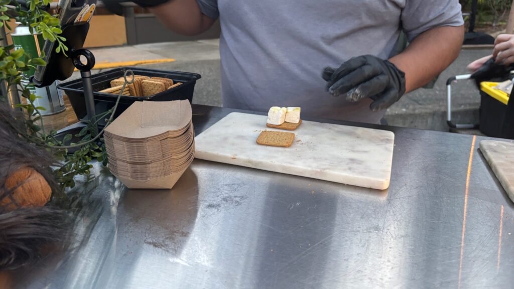 A bowl of white marshmallows beside a measuring cup of crisped rice cereal