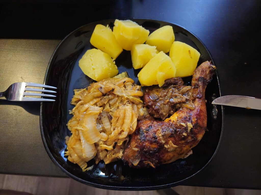 Boneless chicken thighs browning in a single layer in a hot cast iron skillet