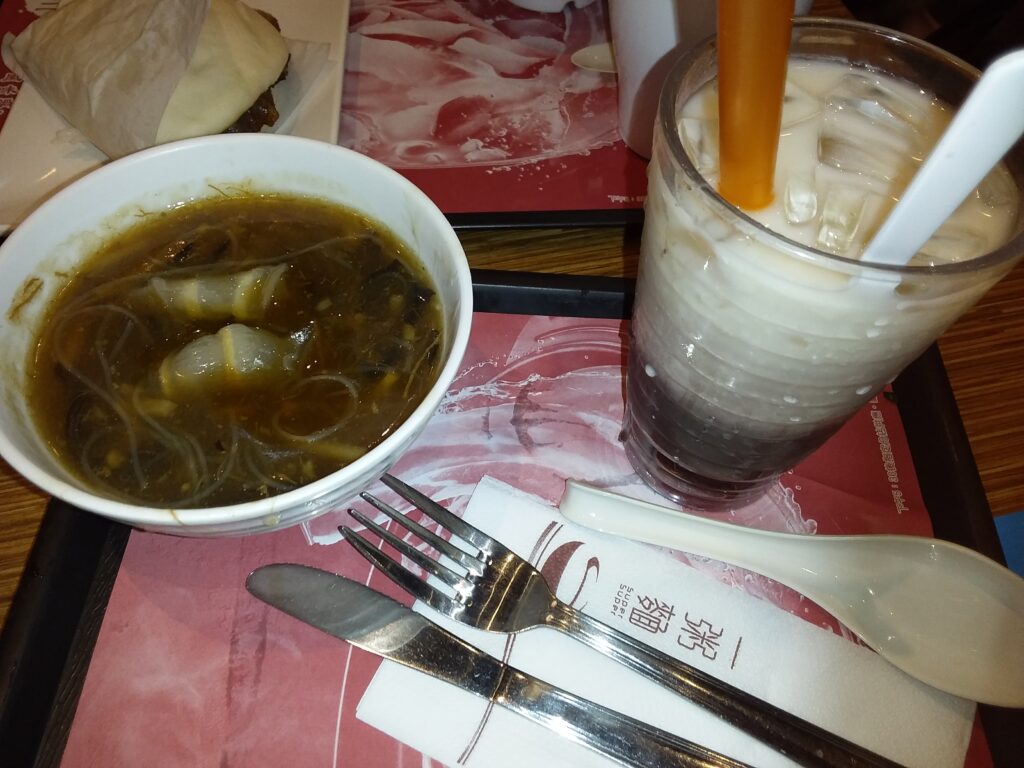 A stainless steel bowl set inside a larger bowl of ice cubes and cold water