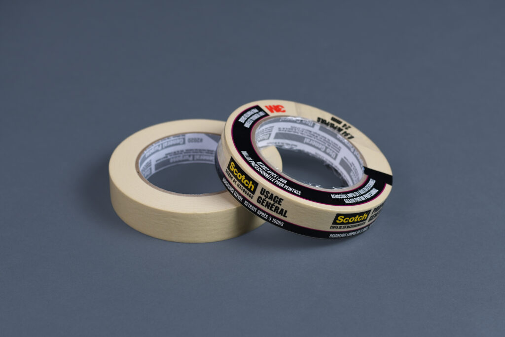 A roll of blue painter's tape and a black permanent marker on a kitchen counter
