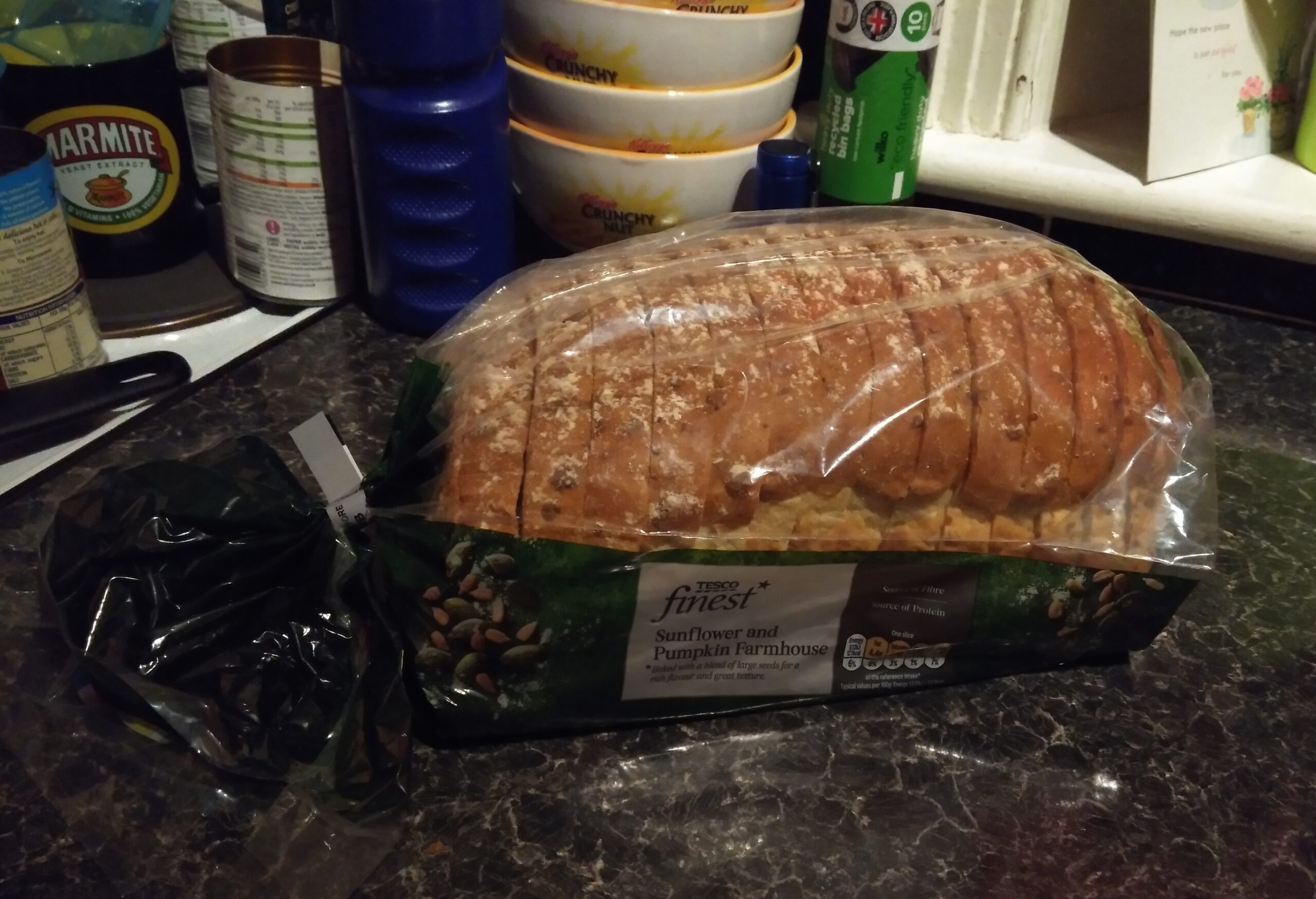 A sliced spiced loaf on a board showing a dark tender crumb and cracked top